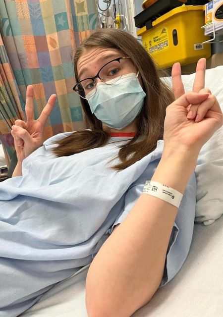 Young woman in hospital wearing oxygen mask during epilepsy treatment and recovery