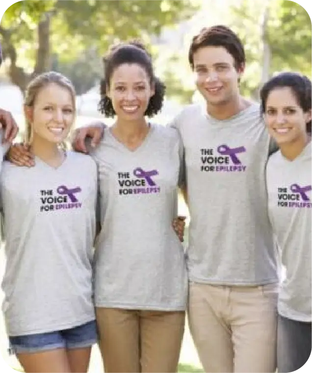Group of volunteers wearing The Voice For Epilepsy charity t-shirts smiling together