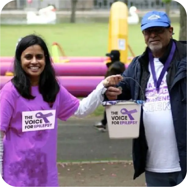 Supporters at epilepsy awareness week event wearing purple and holding charity banners