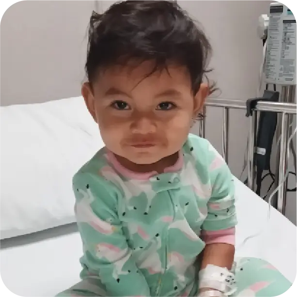 Young child in hospital bed wearing patterned top representing epilepsy patient care