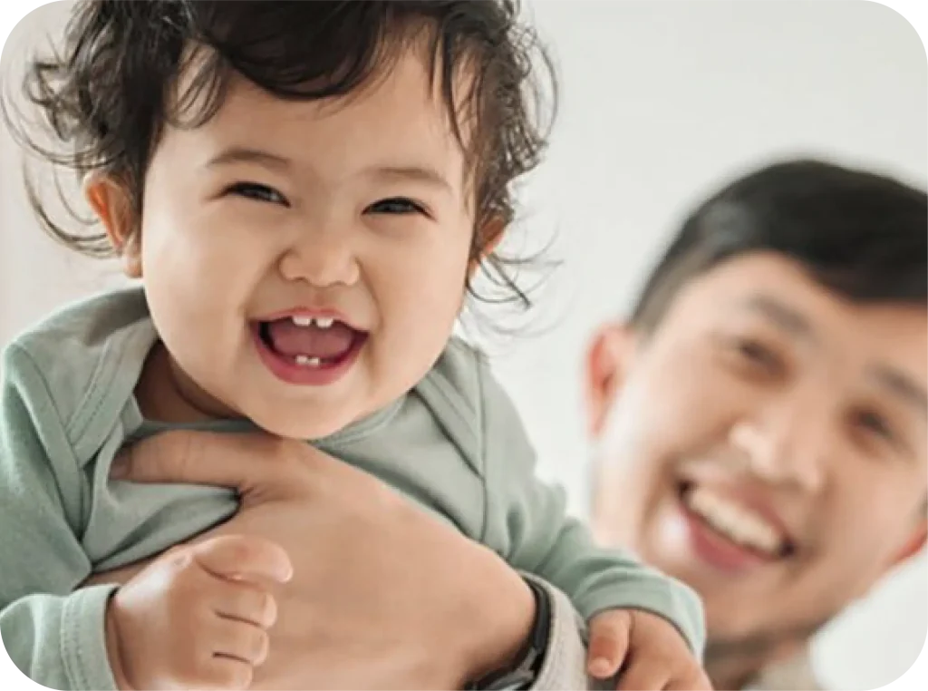 Happy father and baby laughing together, representing family joy and hope for families affected by epilepsy