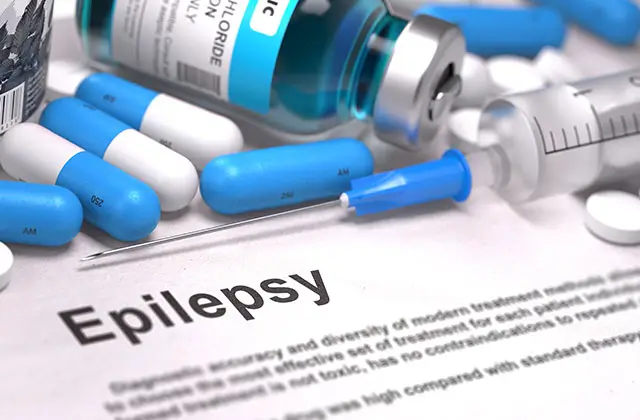 Blue capsules and medication with epilepsy text representing anti-seizure medication