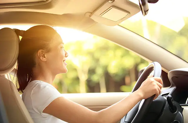 Woman driving a car representing epilepsy and driving considerations