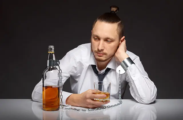 Man with alcohol bottle representing alcohol withdrawal and seizure risk