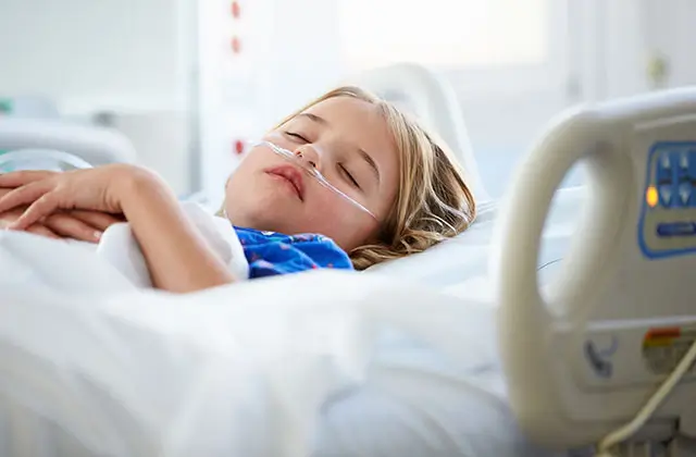 Young child in hospital bed representing epilepsy prevalence