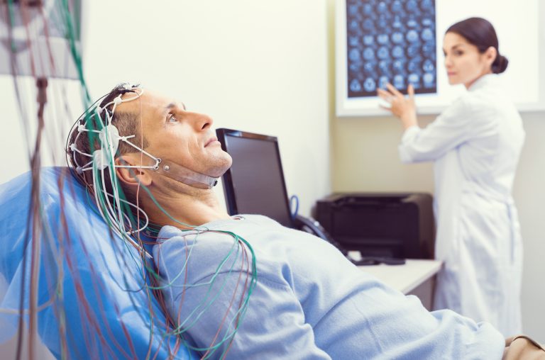Patient undergoing EEG electroencephalography brain scan test for epilepsy diagnosis and seizure monitoring