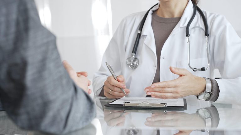 Doctor consulting with patient about epilepsy treatment options and medication during medical appointment