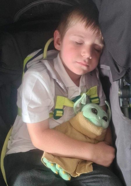 Child with epilepsy sleeping peacefully while hugging stuffed toy during recovery and rest period