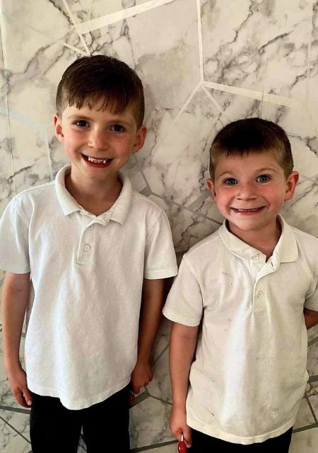 Brothers in school uniforms smiling together showing sibling support for child with epilepsy family story