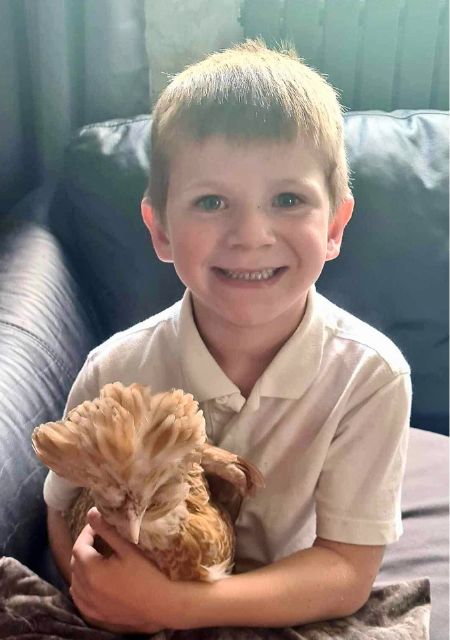 Young boy Toby Hutchinson smiling with pet dog sharing his epilepsy journey and personal story