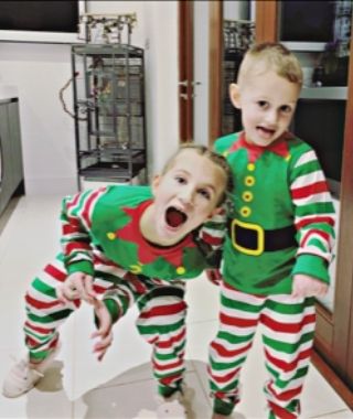 Ava and Harry wearing festive elf costumes at Christmas, celebrating family joy whilst living with epilepsy