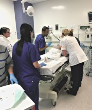 Young patient prepared for epilepsy surgery in operating theatre, surrounded by medical team