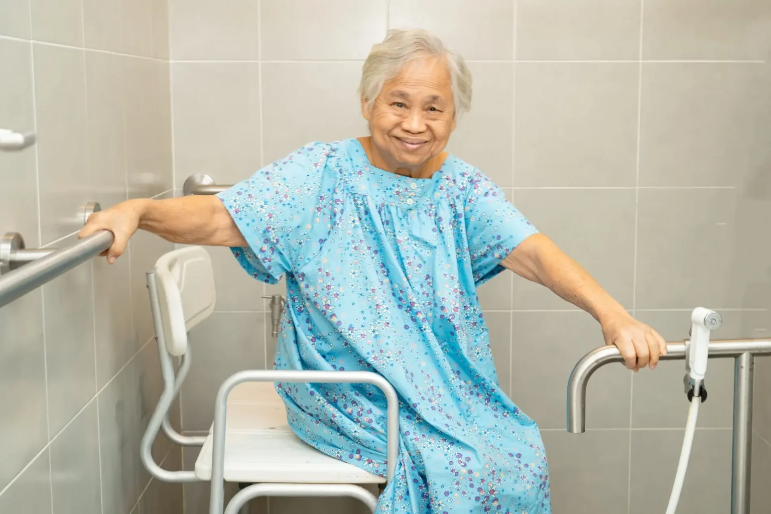 Elderly woman with epilepsy using mobility support equipment rails at home for safety and independence