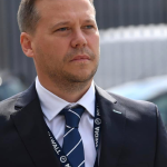 Karl Bates, Voice For Epilepsy team member, professional portrait in business attire with charity tie