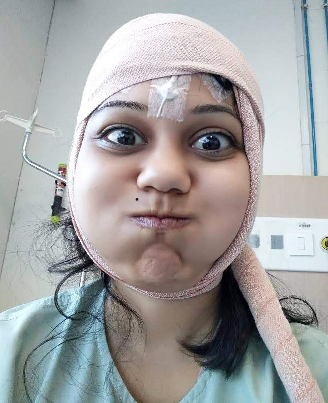 Ketaki Chitale recovering in hospital after epilepsy surgery with head bandage
