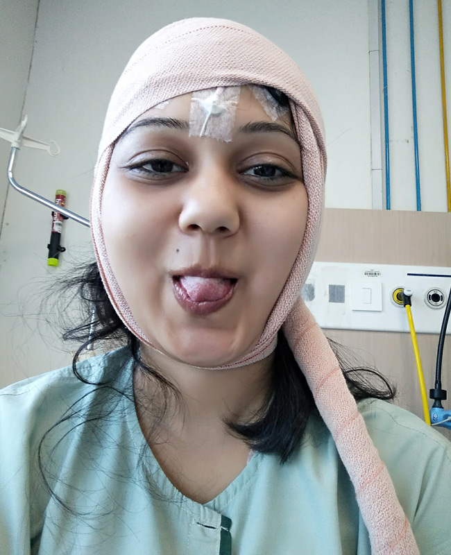 Ketaki Chitale post-surgery selfie in hospital during epilepsy treatment showing her positive spirit