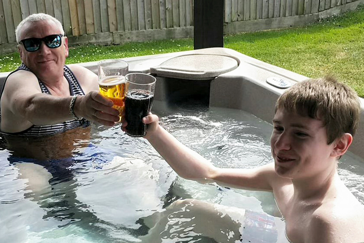 Lewis Clark enjoying time in the hot tub with his grandfather showing quality family time despite epilepsy