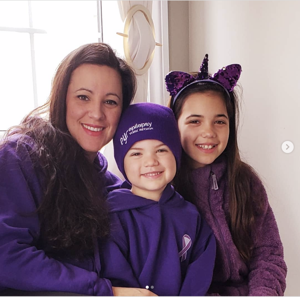 Happy family wearing purple epilepsy awareness clothing celebrating Purple Day for epilepsy support