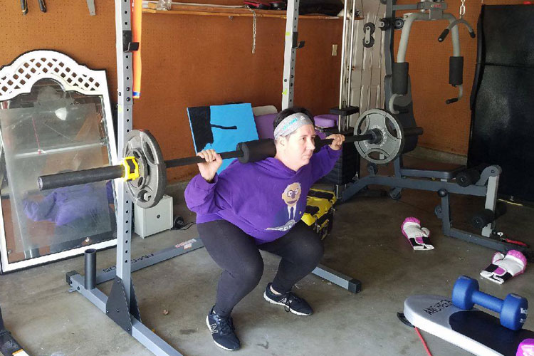 Natalie doing squats in the gym showing active lifestyle whilst living with epilepsy
