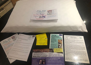 Epilepsy safety information materials and anti-suffocation pillow brochures displayed on table