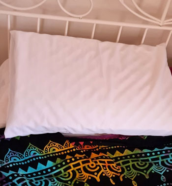 Colorful patterned anti-suffocation safety pillow on bed for epilepsy seizure protection during sleep