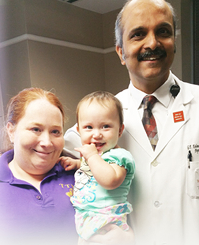 Michelle with her baby and father sharing their family epilepsy journey and story of seizing a cure